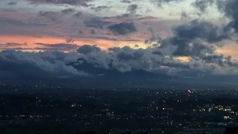 Timelapse of dramatic sunset clouds rolling over hills Stock Footage 323975877