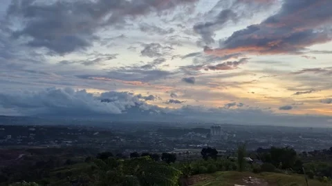Timelapse of dramatic sunset clouds rolling over hills Stock Footage 323976136