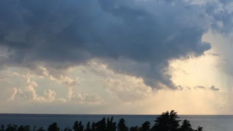 Timelapse of Dramatic Sunset Over the Ocean with Airplane and Storm Clouds Stock Footage 344734636