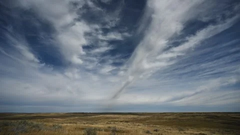 Timelapse of dramatic white summer clouds drifting above a dry desert like Stock Footage 310690667