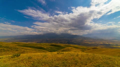 Timelapse of Drifting Clouds Over Golden Rolling Hills in Kyrgyzstan Stock Footage 335688415