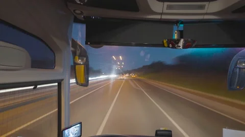 Timelapse from driver's cab. Action. Trucker is driving on suburban highway with Stock Footage 147523950