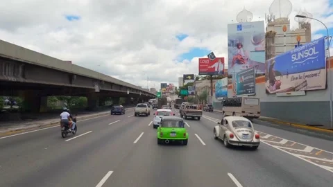 Timelapse driving auto by the La Guaira highway with dense traffic in the center Stock Footage 237768397