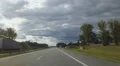 Timelapse of driving on freeway on summer day. Sun hides behind low dark clouds HD Footage