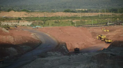 Timelapse of dump truck and Backhoe working in mine with shade of cloud moving Video stock 38532949