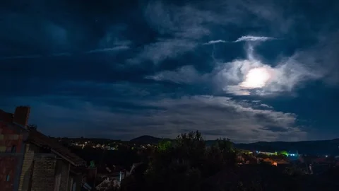 Timelapse during night and full moon above small town Stock Footage 247520998