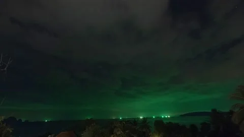 Timelapse during night - fast moving clouds , green light from ships Stock Footage 194433381