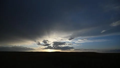 Timelapse of Early Morning Clouds Drifting Over Prairie Hills as Soft Pastel Stock Footage 331683830