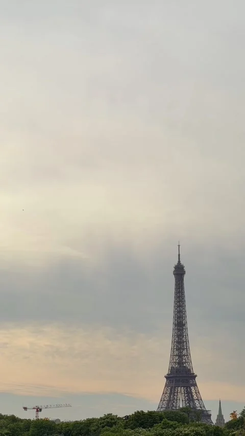 TIMELAPSE | Eiffel Tower in Paris standing against a cloudy sky at sunset Stock Footage 337483566