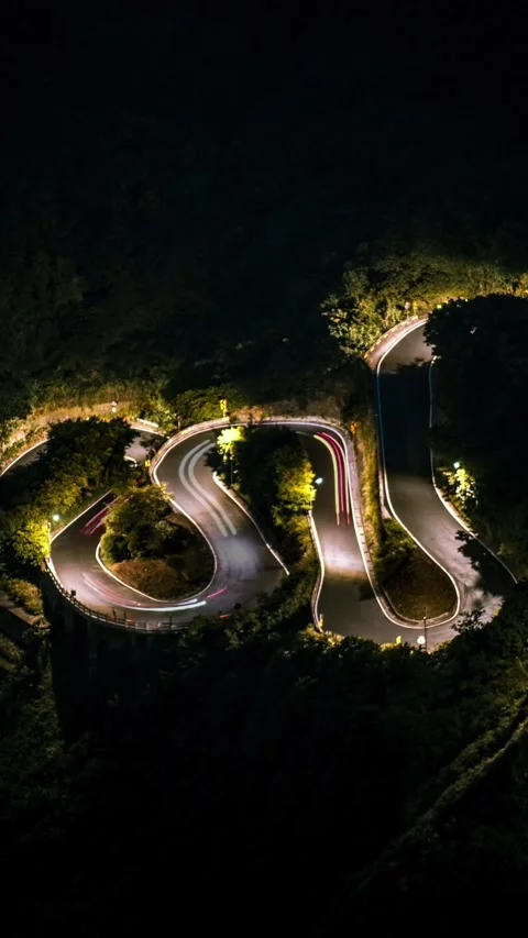 Timelapse elevated view cars driving on beautiful S curved road at night Stock Footage 320901349