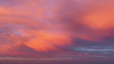 Timelapse of epic red clouds moving fast in the rays of the rising sun Stock Footage 281290764