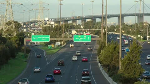 Timelapse evening of busy traffic on freeway with bridge &amp; Melbourne. 動画素材 11240886