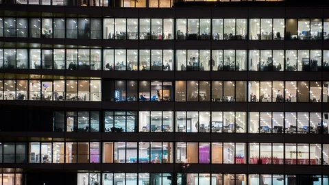 Timelapse at evening of a modern office building with glass windows Stock Footage