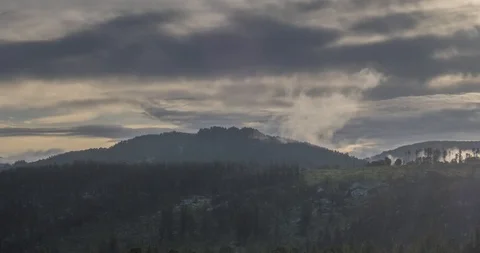 Timelapse of evening sun rays emerging through the cold foggy clouds in the Stock Footage 115094965