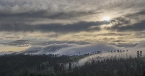 Timelapse of evening sun rays emerging through the cold foggy clouds in the Stock Footage 139980844