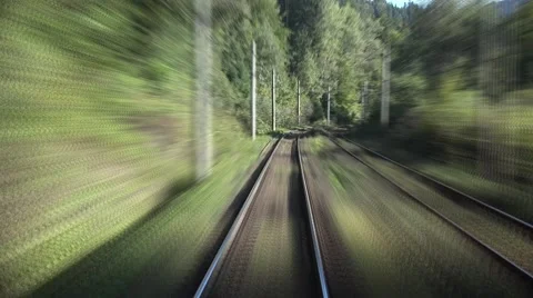 Timelapse of extreme fast motion train passing the mountains and green woods Video stock 67369155