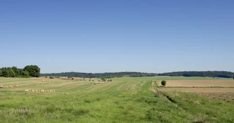 Timelapse of farm work, tractor, harvesting hay bales, summer day Stock Footage 253658716