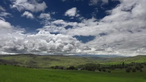 Timelapse farmland patchwork fields moving clouds cropland rural terrain detail Stock Footage 333789133