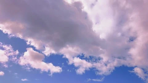 Timelapse of fast-moving clouds against a vibrant blue sky Stock Footage 316933407