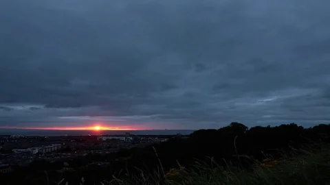 Timelapse of fast moving clouds and the hint of a sunrise over Edinburgh Stock Footage 78139135