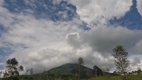 Timelapse of fast moving clouds covering the hills Stock Footage 306672195