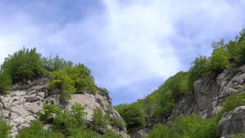 Timelapse of Fast-Moving Clouds Over Mountains Stock Footage 310828301