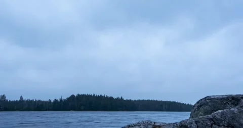 Timelapse of fast moving rain clouds over lake Stock Footage 257339692