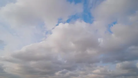 Timelapse - fast moving white clouds in the blue sky - cloudscape Stock Footage 340429045