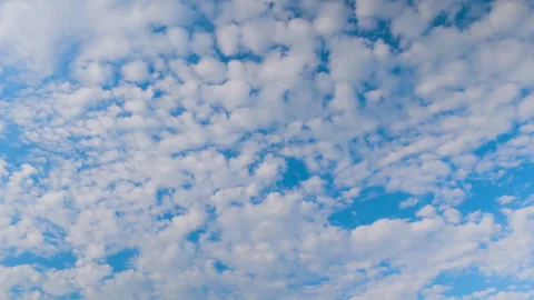 Timelapse - fast moving white clouds in the blue sky - cloudscape Stock Footage 340429314