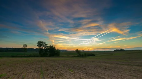 Timelapse of fields under sunset sky with chemtrails 스톡 동영상 58933456