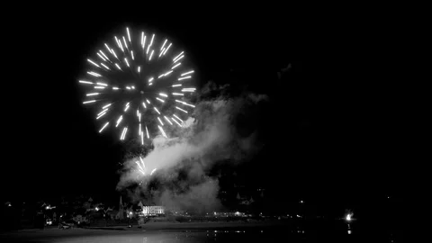 Timelapse of a firework from a beach over a coastal town in black and white. Stock Footage 112658693