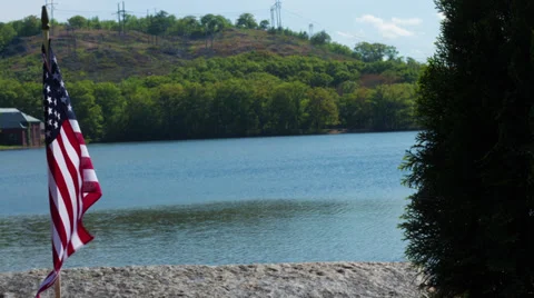 Timelapse of Flag in front of Lake Stock Footage 39499899