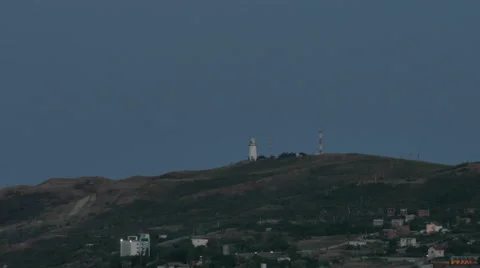 Timelapse Flashing Lighthouse on the Hill During Sunset Over the Village Stock Footage 67592625