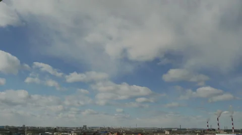Timelapse floating clouds on a blue sky over the city 4K Video stock 48506606