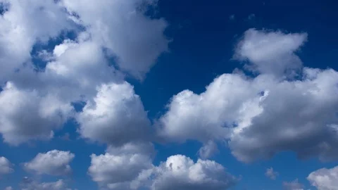 Timelapse of floating clouds on a blue sky Stock Footage 125665616