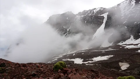 Timelapse of floating clouds in the mountains. Rocks covered with snow. Video stock 113196276