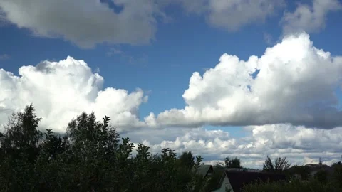 Timelapse of floating clouds in the sky above the village Stock Footage 283648913