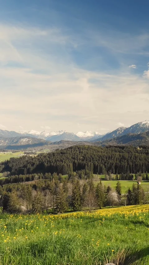 Timelapse of flowing clouds over expansive foothills and mountain vistas, cre Stock Footage 309227616