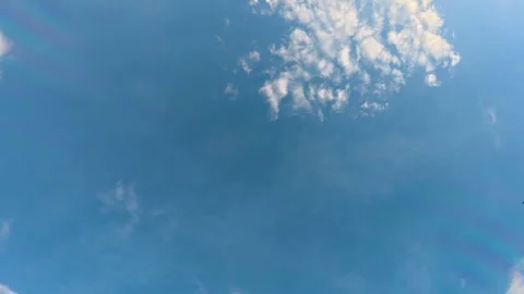 Timelapse of fluffy clouds drifting across a clear blue sky Stock Footage 310163625