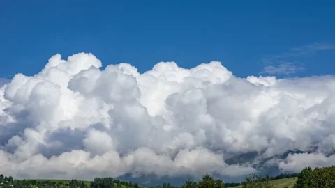 Timelapse of fluffy clouds rapidly rising above mountain range. Stock Footage 138588962