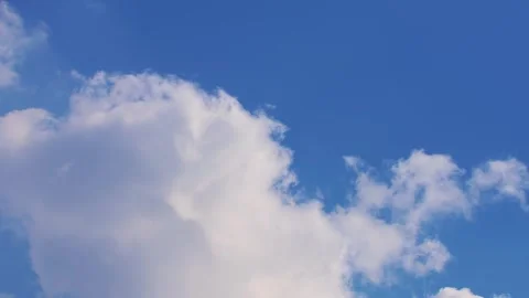 Timelapse of fluffy white clouds against blue sky Stock Footage 278030733