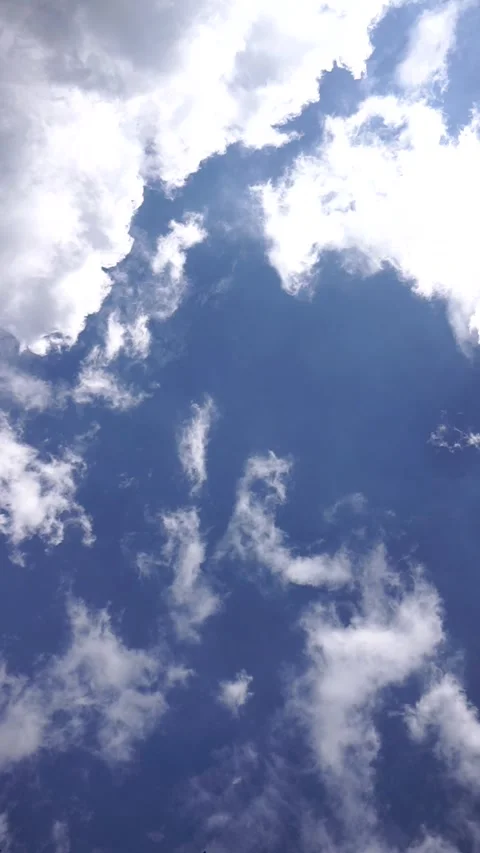 Timelapse of fluffy white clouds drifting across a deep blue sky Stock Footage 326305007