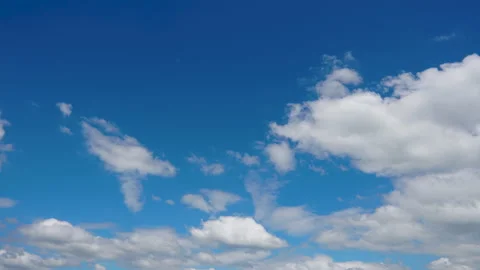 Timelapse fluffy white clouds moving on blue sky in the day Stock Footage 163685610