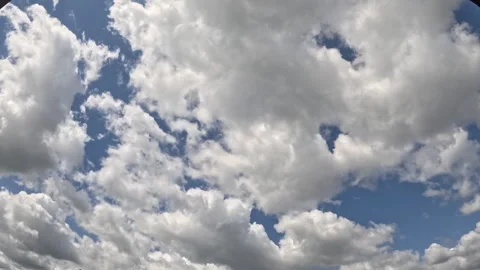 Timelapse of fluffy white clouds. Video of clouds flying across the blue sky Stock Footage 284214880