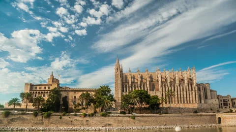 Timelapse with flying clouds over Cathedral of Palma de Mallorca and Almudaina Stock Footage 62057117