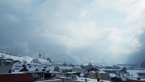 Timelapse of fog and clouds passing over small mountain city called Engelberg Stock Footage 129099371