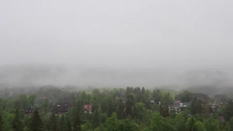 Timelapse of fog rolling over the Tatra mountain range with light rain and .. Vídeos de archivo 329063579