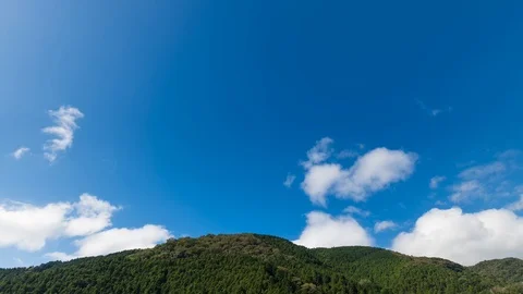 Timelapse footage of clouds moving over green hill in Izu Peninsula, Japan Stock Footage 118485239