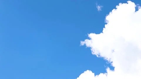Timelapse footage of clouds moving on wind forming white cloudscape on sunny day Stock Footage 247435011