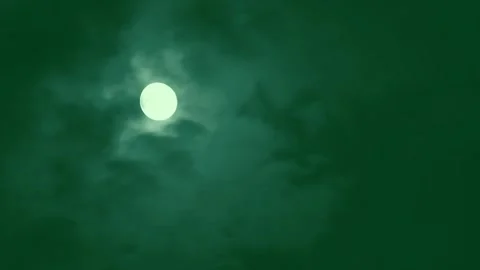 Timelapse footage of full moon moving across cloudy green night sky with Stock Footage 340943396